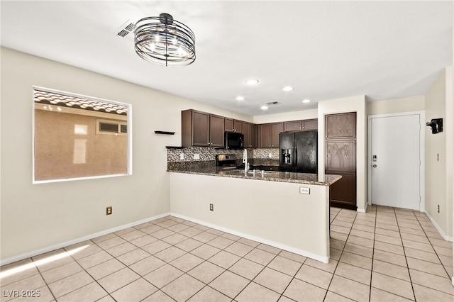 6044 Seneca Springs St, Las Vegas, NV 89130 - kitchen with black appliances, dark brown cabinetry, decorative backsplash, light tile patterned floors, and a peninsula