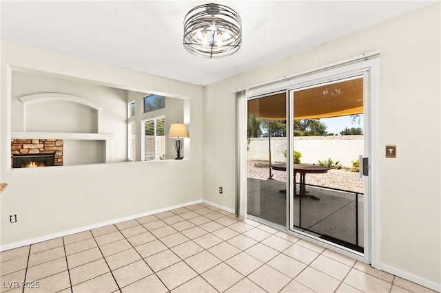 6044 Seneca Springs St, Las Vegas, NV 89130 - empty room featuring plenty of natural light and a stone fireplace