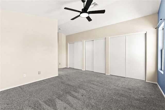 6044 Seneca Springs St, Las Vegas, NV 89130 - unfurnished bedroom featuring two closets, carpet, lofted ceiling, and a ceiling fan