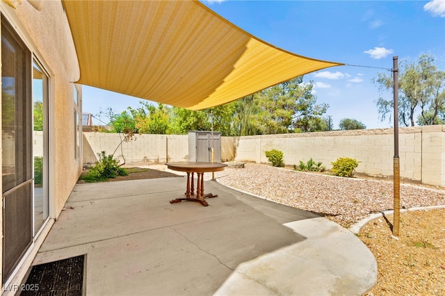 6044 Seneca Springs St, Las Vegas, NV 89130 - fenced backyard featuring a patio and a storage unit