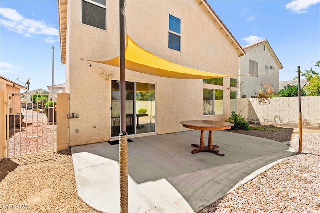 6044 Seneca Springs St, Las Vegas, NV 89130 - rear view of property with stucco siding and a patio area