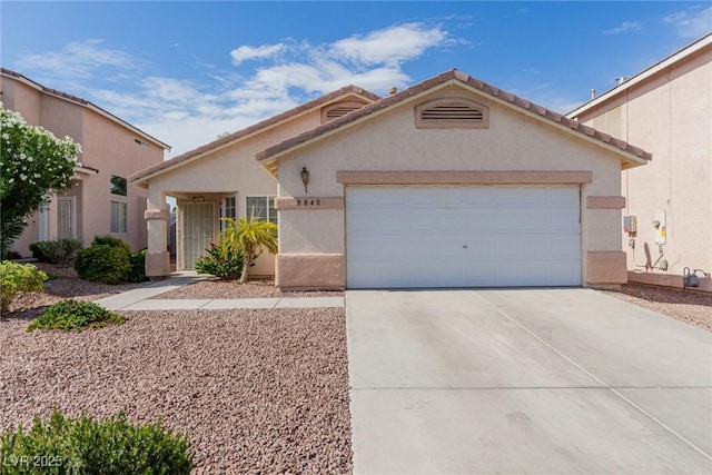 8840 Spinning Wheel Ave, Las Vegas, NV 89143 - view of front of property featuring driveway, a garage, stucco siding, and a tiled roof