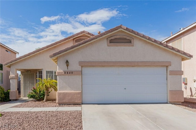 8840 Spinning Wheel Ave, Las Vegas, NV 89143 - view of front of property featuring driveway, a garage, and stucco siding