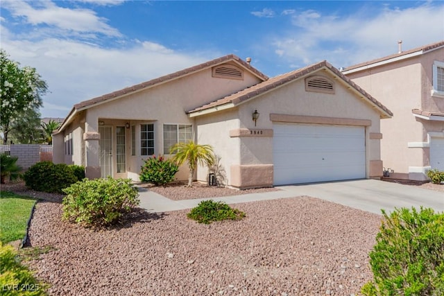 8840 Spinning Wheel Ave, Las Vegas, NV 89143 - view of front of home featuring an attached garage, stucco siding, driveway, and a tile roof