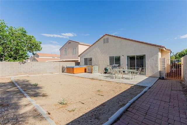 8840 Spinning Wheel Ave, Las Vegas, NV 89143 - rear view of property featuring stucco siding, a patio, a fenced backyard, and a hot tub