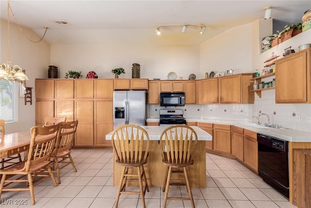 8840 Spinning Wheel Ave, Las Vegas, NV 89143 - kitchen with black appliances, open shelves, light tile patterned floors, and a kitchen island