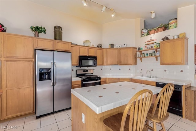 8840 Spinning Wheel Ave, Las Vegas, NV 89143 - kitchen featuring black appliances, light tile patterned flooring, tile countertops, a center island, and open shelves