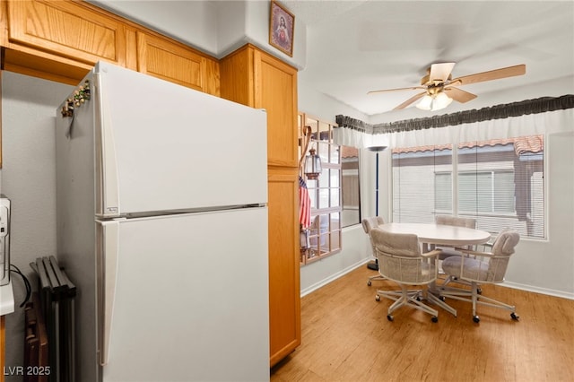 3152 Tarpon Dr Unit 203, Las Vegas, NV 89120 - kitchen featuring freestanding refrigerator, light wood finished floors, and a ceiling fan