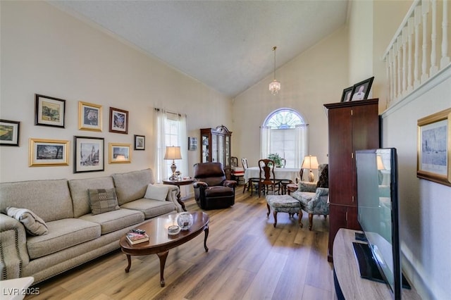 1939 Guinn Dr, Henderson, NV 89074 - living area featuring wood finished floors, high vaulted ceiling, and healthy amount of natural light