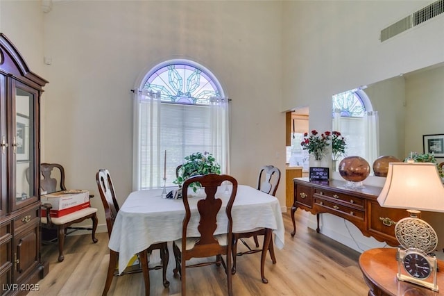 1939 Guinn Dr, Henderson, NV 89074 - dining area with a towering ceiling, light wood-style floors, and plenty of natural light