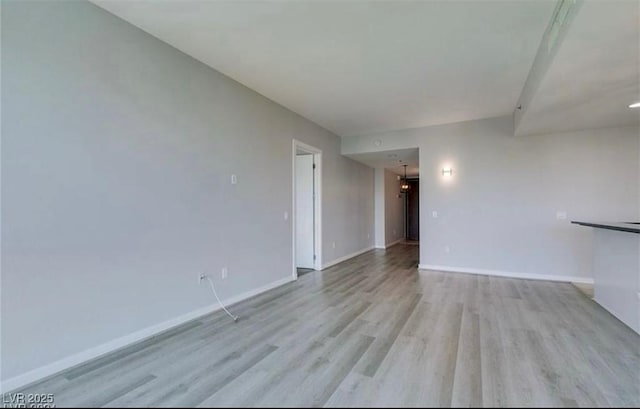 4575 Dean Martin Dr Unit 406, Las Vegas, NV 89103 - unfurnished living room with light wood-style floors and baseboards
