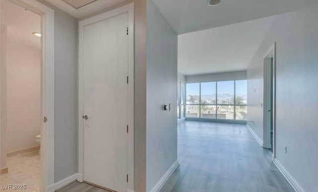 4575 Dean Martin Dr Unit 406, Las Vegas, NV 89103 - hallway with baseboards and light wood-type flooring