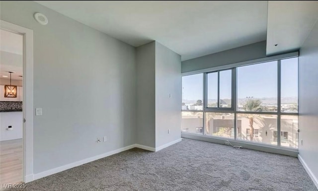 4575 Dean Martin Dr Unit 406, Las Vegas, NV 89103 - spare room featuring carpet flooring, plenty of natural light, and a smoke detector
