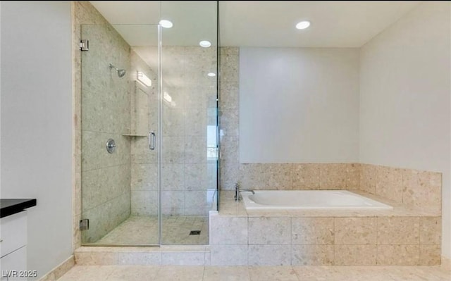 4575 Dean Martin Dr Unit 406, Las Vegas, NV 89103 - bathroom featuring a garden tub, a stall shower, vanity, recessed lighting, and tile patterned flooring