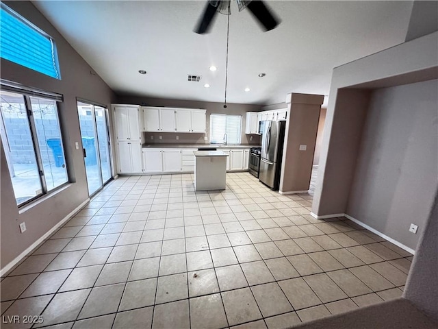 5513 Oakwood Ridge St, Las Vegas, NV 89130 - kitchen with appliances with stainless steel finishes, a kitchen island, ceiling fan, light tile patterned floors, and white cabinetry