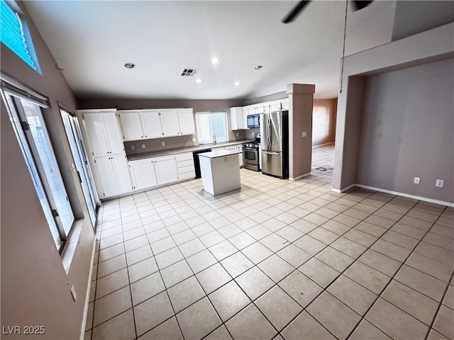 5513 Oakwood Ridge St, Las Vegas, NV 89130 - kitchen featuring stainless steel appliances, light tile patterned flooring, white cabinetry, recessed lighting, and a center island