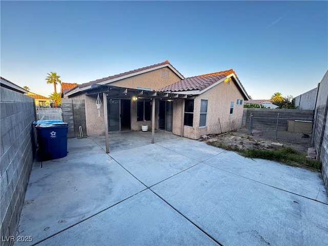 5513 Oakwood Ridge St, Las Vegas, NV 89130 - back of house with a patio, a fenced backyard, stucco siding, and a tiled roof