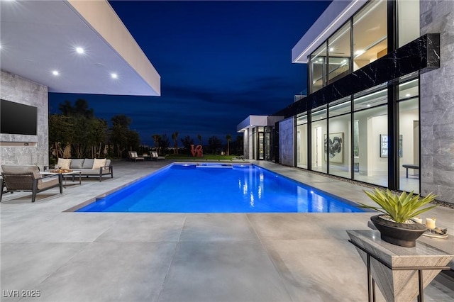 10891 Stardust Dr, Las Vegas, NV 89135 - pool at twilight featuring an outdoor living space, a patio area, and an outdoor pool