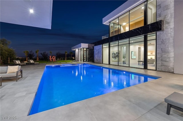 10891 Stardust Dr, Las Vegas, NV 89135 - pool at twilight featuring a patio and an outdoor pool