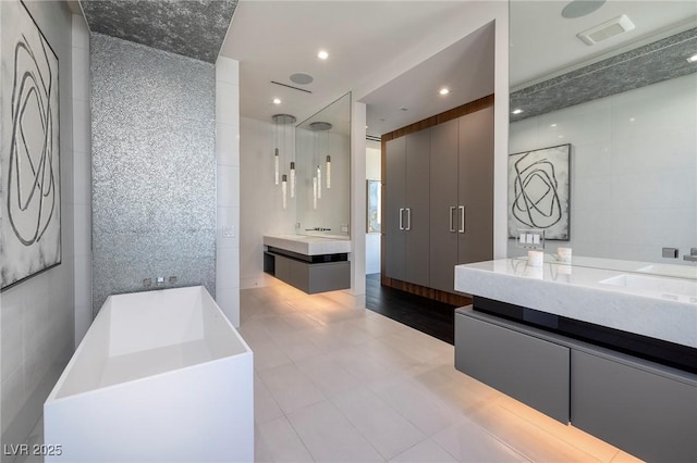 10891 Stardust Dr, Las Vegas, NV 89135 - full bath featuring tile walls, a freestanding tub, and two vanities