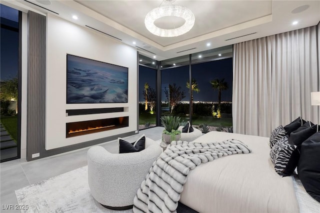 10891 Stardust Dr, Las Vegas, NV 89135 - bedroom with finished concrete flooring, a lit fireplace, a tray ceiling, recessed lighting, and access to outside
