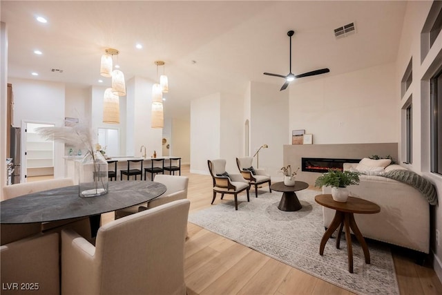 4065 Genoa Dr, Las Vegas, NV 89141 - living room with wood finished floors, recessed lighting, a ceiling fan, and a glass covered fireplace