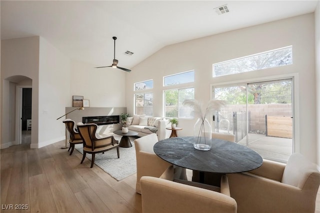 4065 Genoa Dr, Las Vegas, NV 89141 - dining area with arched walkways, hardwood / wood-style floors, healthy amount of natural light, a ceiling fan, and lofted ceiling