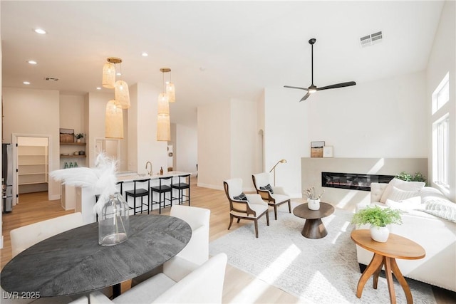 4065 Genoa Dr, Las Vegas, NV 89141 - living room featuring a glass covered fireplace, light wood-style floors, recessed lighting, and ceiling fan