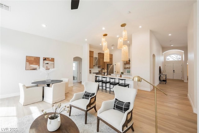 4065 Genoa Dr, Las Vegas, NV 89141 - living room with arched walkways, light wood-type flooring, and recessed lighting