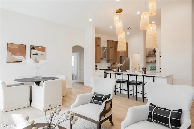 4065 Genoa Dr, Las Vegas, NV 89141 - living area featuring arched walkways, light wood-type flooring, and recessed lighting