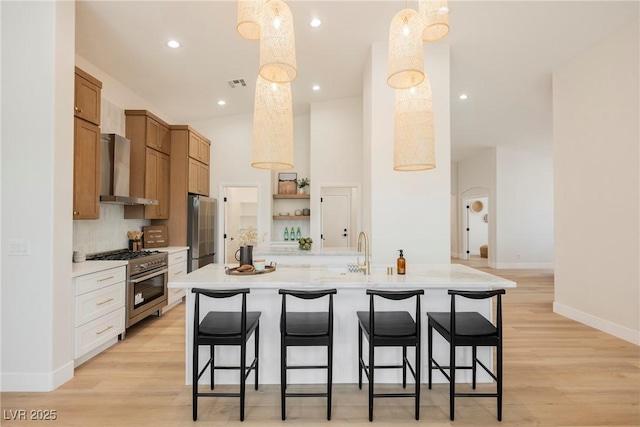 4065 Genoa Dr, Las Vegas, NV 89141 - kitchen featuring wall chimney exhaust hood, appliances with stainless steel finishes, light countertops, a breakfast bar, and open shelves