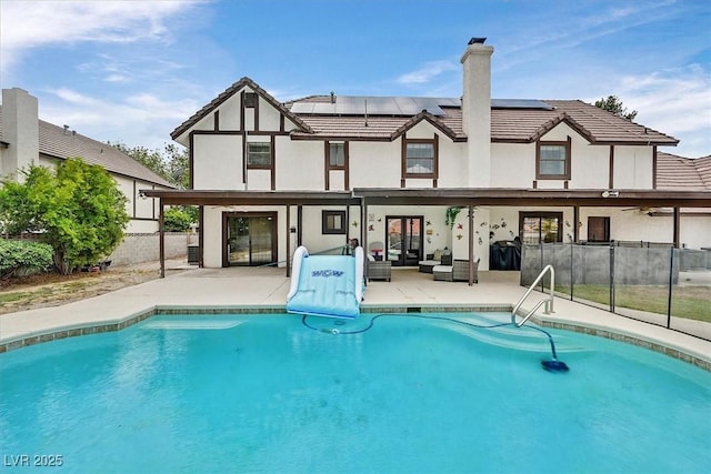 2740 Family Ct, Las Vegas, NV 89117 - back of house with a patio area, solar panels, a chimney, and an outdoor living space