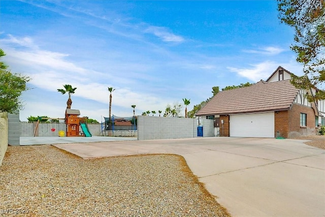 2740 Family Ct, Las Vegas, NV 89117 - view of yard featuring a playground, a garage, and concrete driveway