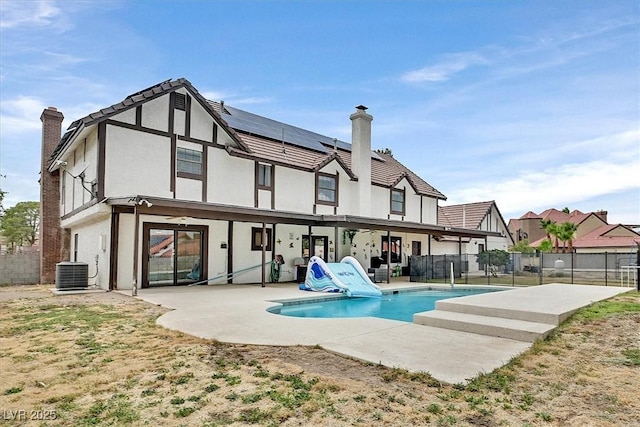 2740 Family Ct, Las Vegas, NV 89117 - back of house featuring a chimney, a patio area, a fenced backyard, and solar panels