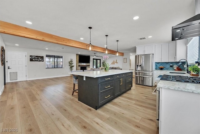 2740 Family Ct, Las Vegas, NV 89117 - kitchen featuring stainless steel fridge, open floor plan, range hood, white cabinets, and recessed lighting
