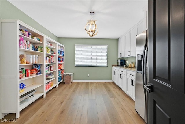 2740 Family Ct, Las Vegas, NV 89117 - kitchen with white cabinets, a chandelier, open shelves, light wood-style floors, and decorative light fixtures