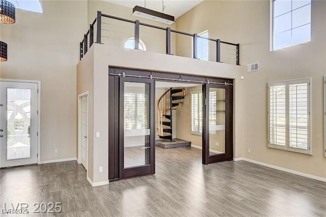 8113 Gothic Ave, Las Vegas, NV 89117 - foyer entrance with french doors, wood finished floors, a towering ceiling, and stairway