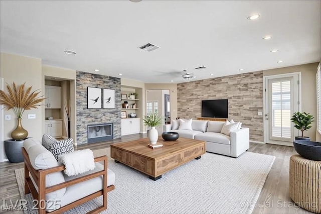 8113 Gothic Ave, Las Vegas, NV 89117 - living area with a fireplace, recessed lighting, a ceiling fan, light wood finished floors, and built in features