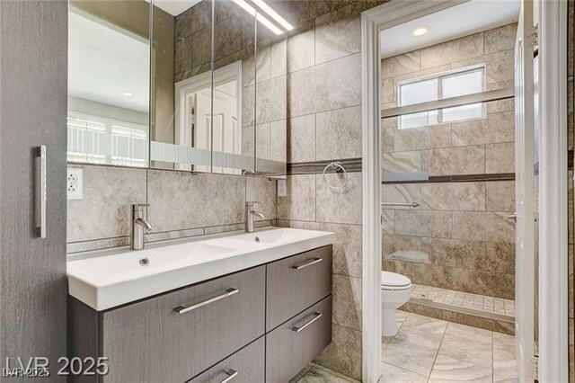 8113 Gothic Ave, Las Vegas, NV 89117 - full bath with tile walls, double vanity, and a tile shower