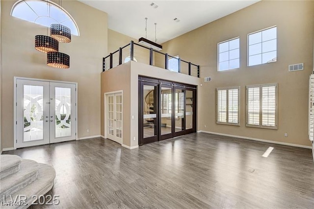 8113 Gothic Ave, Las Vegas, NV 89117 - foyer entrance featuring french doors, a high ceiling, wood finished floors, and a chandelier
