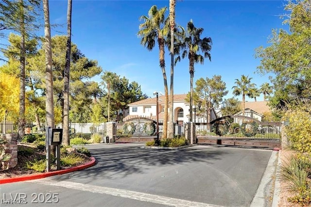 8113 Gothic Ave, Las Vegas, NV 89117 - view of asphalt street featuring a gate, curbs, and a gated entry