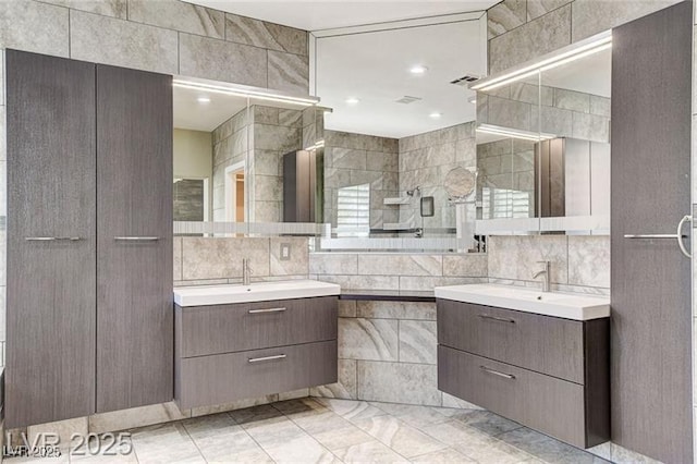 8113 Gothic Ave, Las Vegas, NV 89117 - bathroom featuring tile walls, two vanities, and backsplash