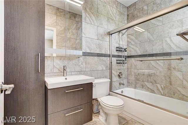 8113 Gothic Ave, Las Vegas, NV 89117 - bathroom featuring tile walls, vanity, bath / shower combo with glass door, and tile patterned floors