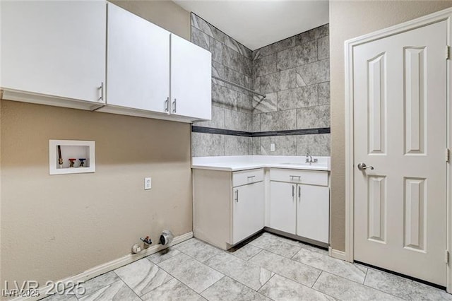 8113 Gothic Ave, Las Vegas, NV 89117 - washroom featuring washer hookup, light tile patterned floors, cabinet space, and hookup for a gas dryer