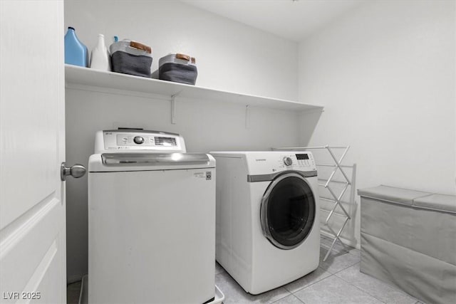 6301 Beavertail Pond Ave, Las Vegas, NV 89122 - laundry room with washing machine and clothes dryer and light tile patterned floors