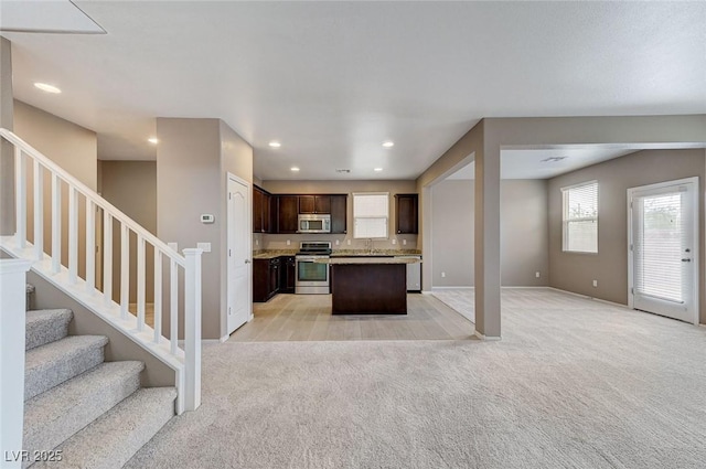 7534 Earnshaw Ave, Las Vegas, NV 89179 - kitchen featuring stainless steel appliances, open floor plan, light carpet, and recessed lighting