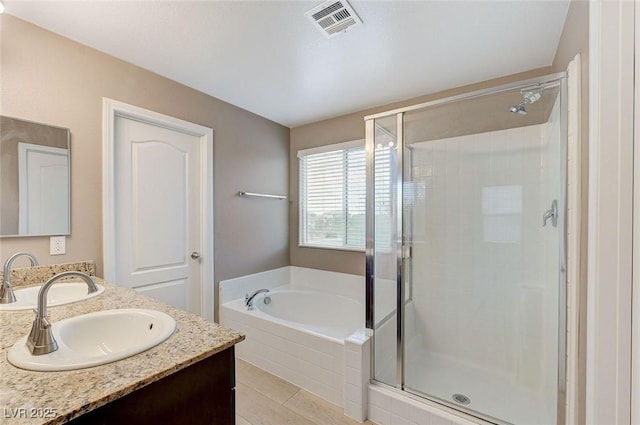 7534 Earnshaw Ave, Las Vegas, NV 89179 - full bathroom with a stall shower, double vanity, a garden tub, and tile patterned floors