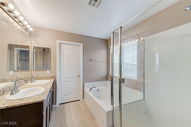 7534 Earnshaw Ave, Las Vegas, NV 89179 - full bathroom with a shower stall, a bath, double vanity, and wood finished floors