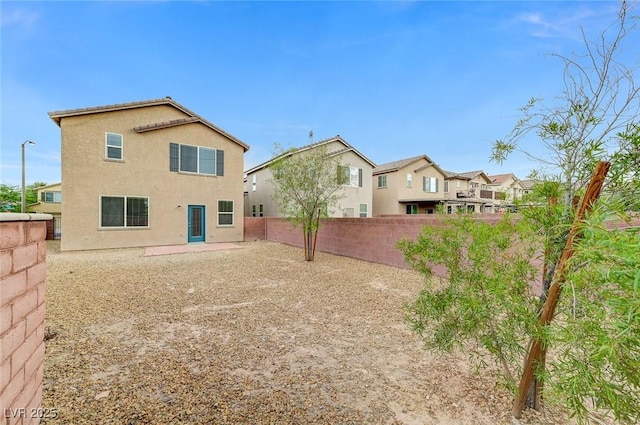 7534 Earnshaw Ave, Las Vegas, NV 89179 - rear view of property with a fenced backyard, stucco siding, and a residential view