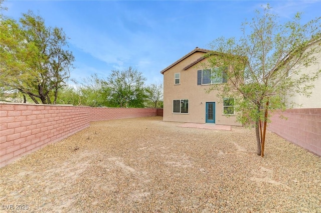 7534 Earnshaw Ave, Las Vegas, NV 89179 - back of house featuring a fenced backyard and stucco siding